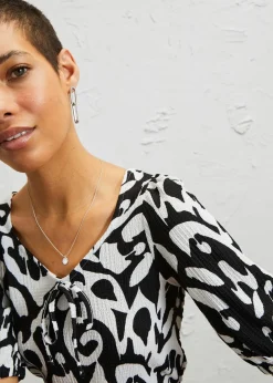 bonprix Bekleidung·Pullover & Strickjacken|Kleider|Kleid aus Jersey-Crêpe mit langem Schlitz schwarz/wollweiß bedruckt